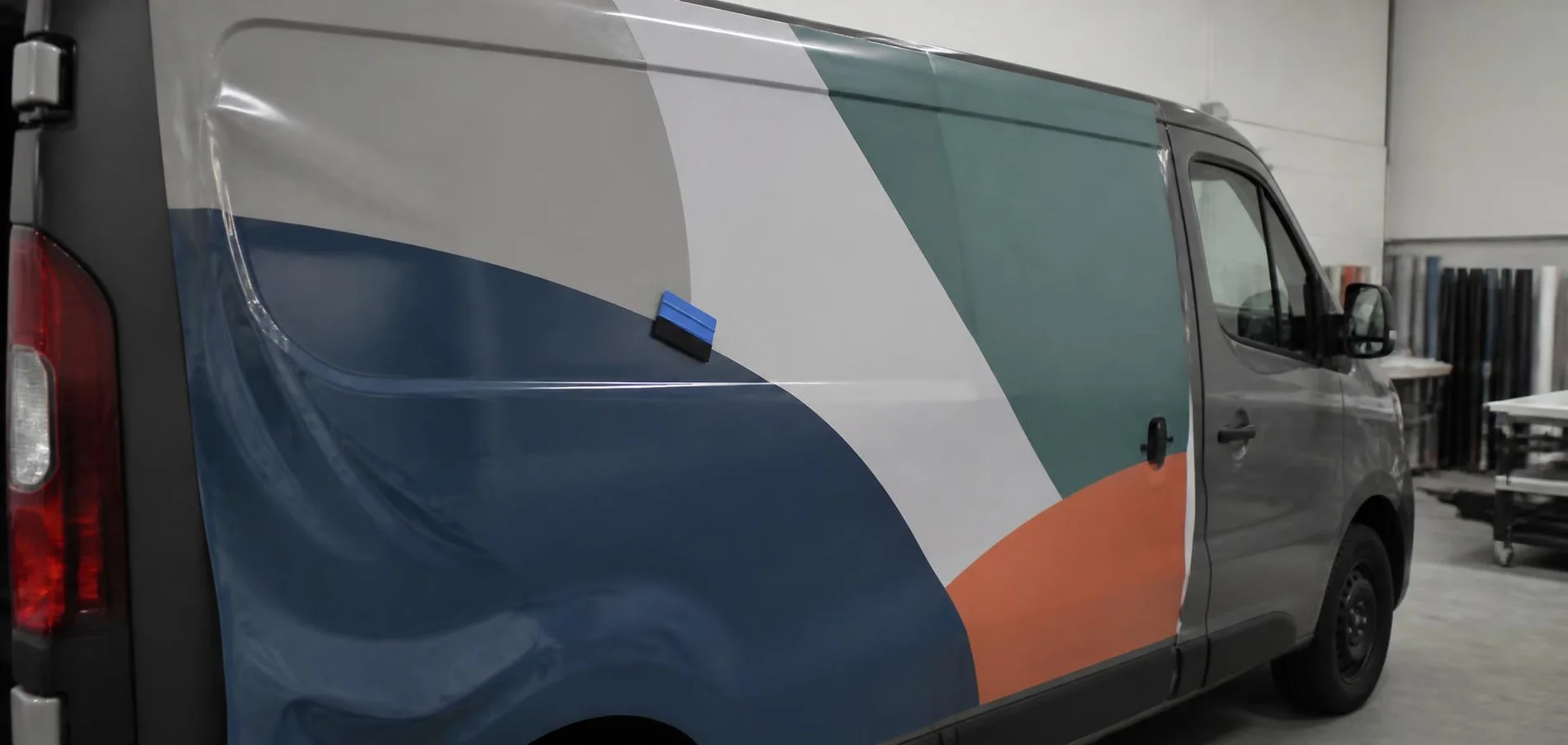 Van side panel with a plain colour-block vinyl graphic being applied — TKM Smash Repairs, Edmonton QLD