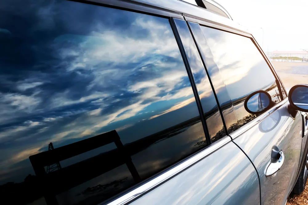 Tinted SUV window reflecting the sky after detail work — TKM Smash Repairs, Edmonton QLD